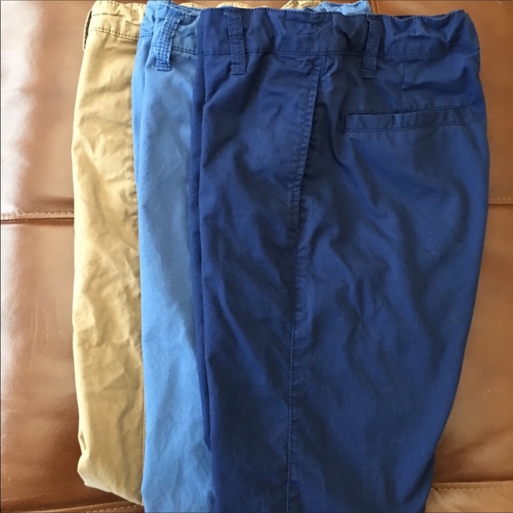 A bundle of three pairs of boys chino pants